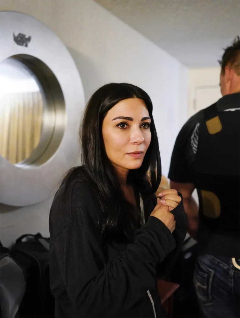 marisol nichols sitting in a hotel room coordinating with police