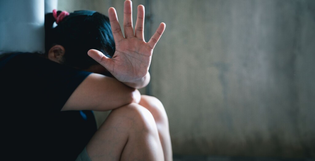abused girl holding her hand out for help